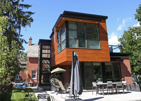 Cedar-clad modern addition with patio